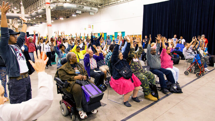 Individuals listen to a speaker at the Access Chicago Expo