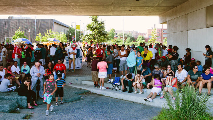 Families gathered in a public square on a sunny day|El Paseo Community Garden