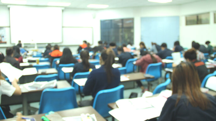 Students seated at desks in a high school classroom