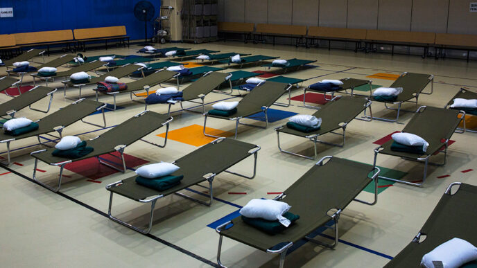 Rows of empty cots in an emergency shelter await people displaced by Hurricane Florence