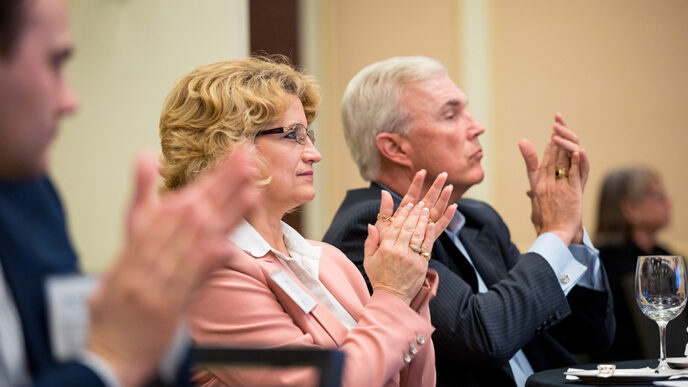 A group of people seated in a meeting room