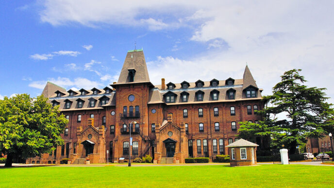 A large red brick building with a large lawn in front|Nate Sutton|Mallory Sutton