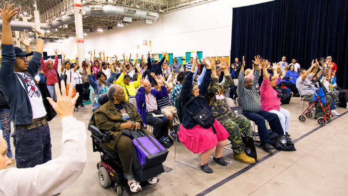 Individuals listen to a speaker at the Access Chicago Expo