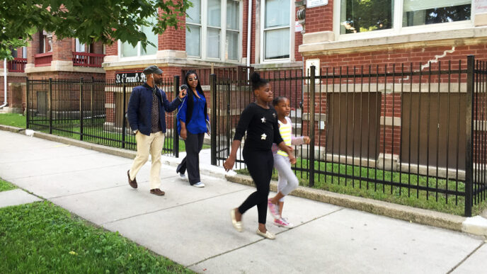 Washington Park resident Sheenita Robinson and her daughters lead CHIRP reporter Christopher Johnson on a neighborhood tour