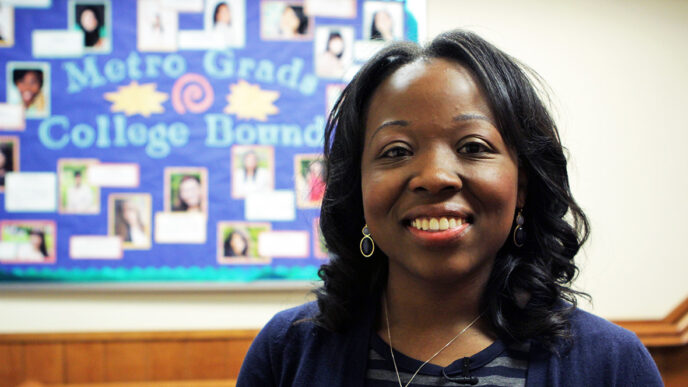 Dr. Yaa Owusu in front of a bulletin board at the Midtown Education Foundation