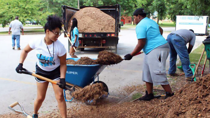 Students apply mulch to neighborhood trees at the Save Chicago Day service projects|