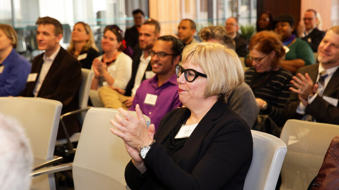 Attendees applaud at the LGBT Community Fund's first-ever grant reception|Representatives from the Chicago Black Gay Men's Caucus accept a grant check at the LGBT Community fund grant reception|