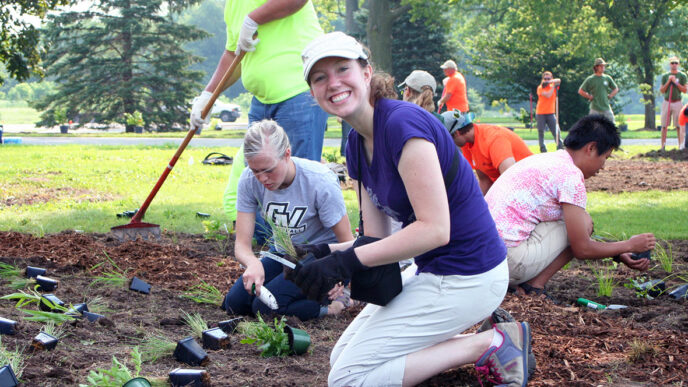Catherine Game and other volunteers planting perennials