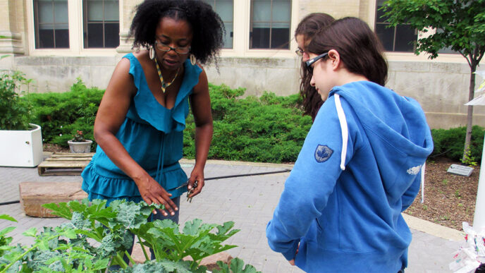 Sonya Harper shows students a community garden in Englewood
