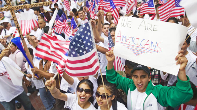 Latinos hold American flags and signs at a rally|Latinos hold American flags and signs at a rally|
