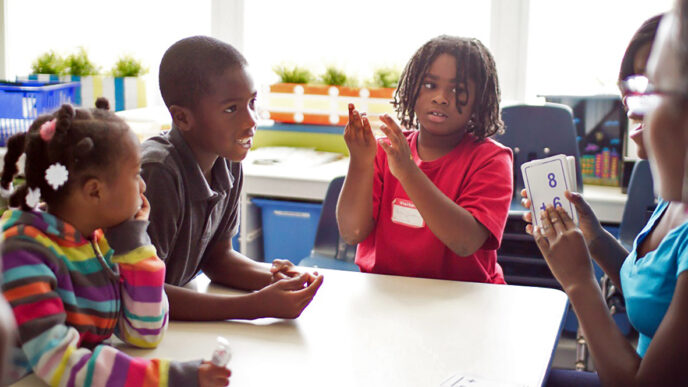 Students at Breakthrough Youth Network use flash cards to practice math problems|A teacher talks with a class of young girls|Two students share a hug in the courtyard at Breakthrough Youth Network