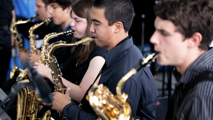 A group of high school students playing saxophones