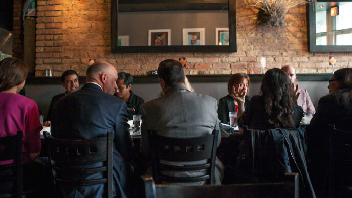 Guests in conversation around a breakfast table during On the Table 2015