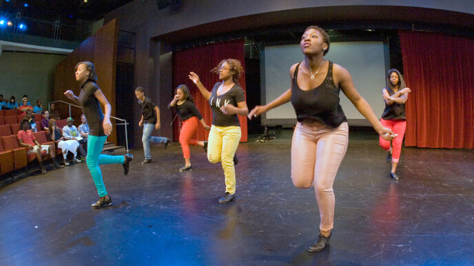 A group of tap dancers on stage at the Arts Infusion Expo