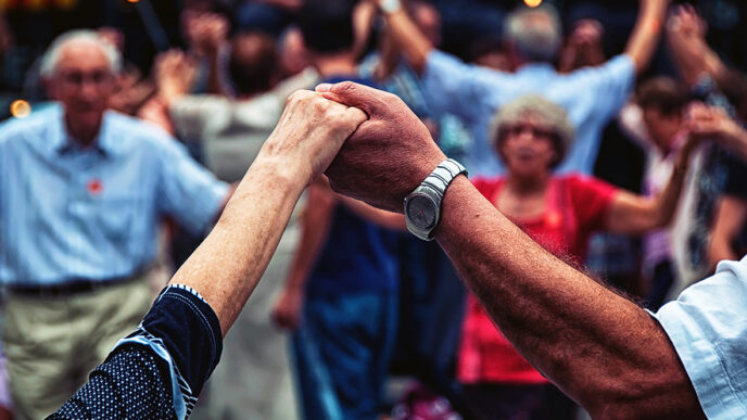 Two people holding hands in a group of dancers