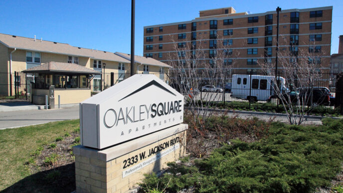 Entrance to the Oakley Square apartment complex|Nurse practitioner Terry Gallagher takes a patient's blood pressure|Rose Mabwa and Oakley Square residents in conversation