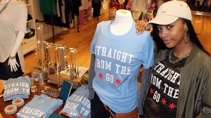 Raven Smith with a display of her Straight from the Go-brand merchandise|