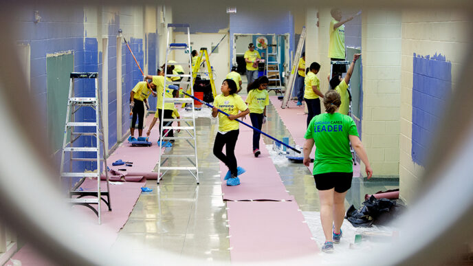 Students repaint a school hallway