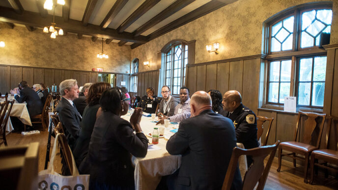 Community and police leaders gather around breakfast tables at On the Table 2016|A group i conversation over breakfast at the Hull House Museum during On the Table 2016|Journalist Robin Robinson at On the Table 2016|