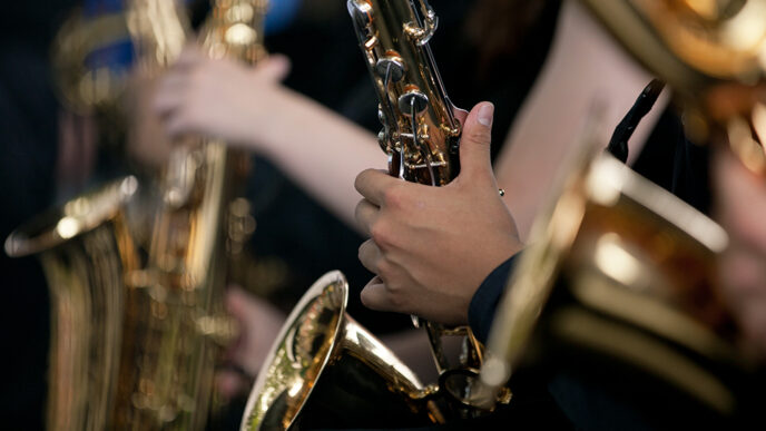 Detail of students' hands playing saxophones