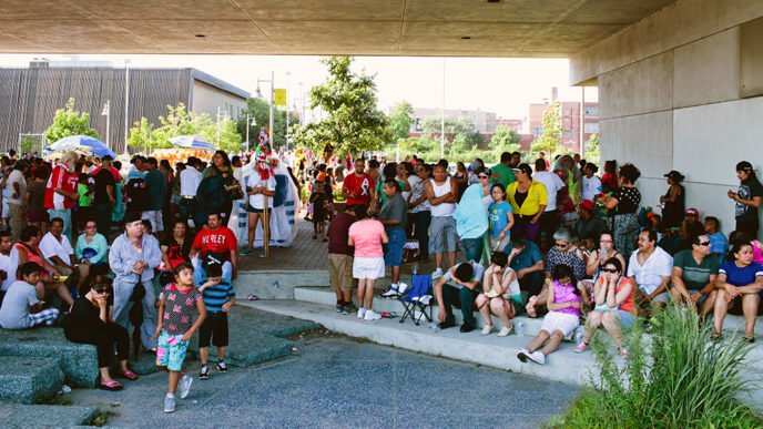Families gathered in a public square on a sunny day|El Paseo Community Garden