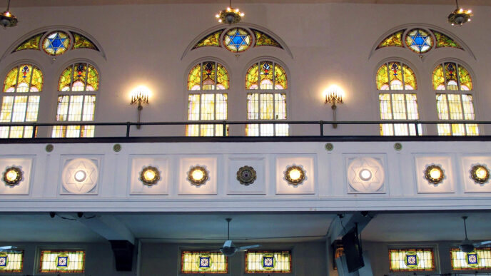 Stained glass windows at the Stone Temple Missionary Baptist Church depicting stars of David|Members of a church choir and congregation singing|Flyer promoting a March For Freedom on July 25