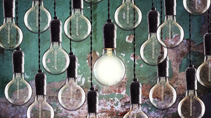 A series of light bulbs hanging against a colorfully painted wall