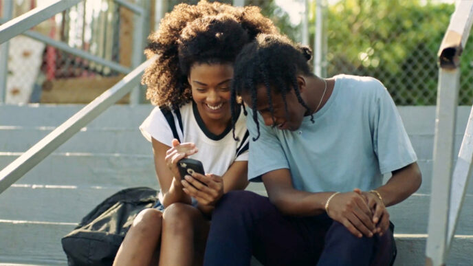 Two teenagers sitting on steps outside