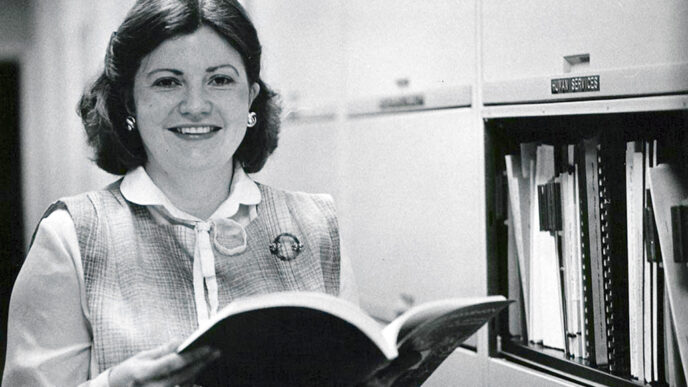 Barbara Long holds a book in the Trust archives|Cover of the Declaration of Trust document