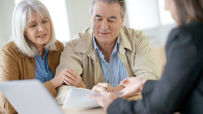 Baby boomer couple talks with a financial advisor