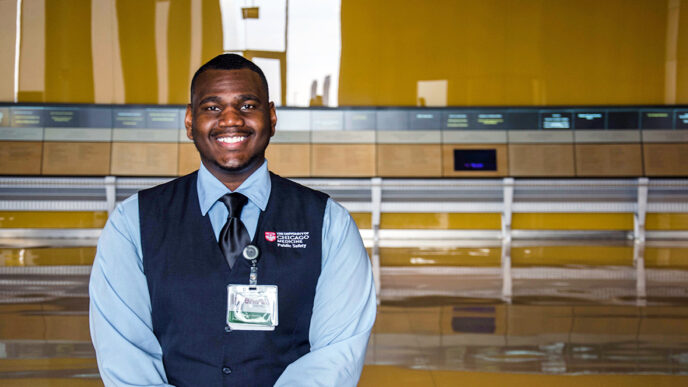 Charles Gentry at the University of Chicago Medical Center|Gentry standing beside a sign on the University campus|Gentry sits at a security desk and greets a visitor