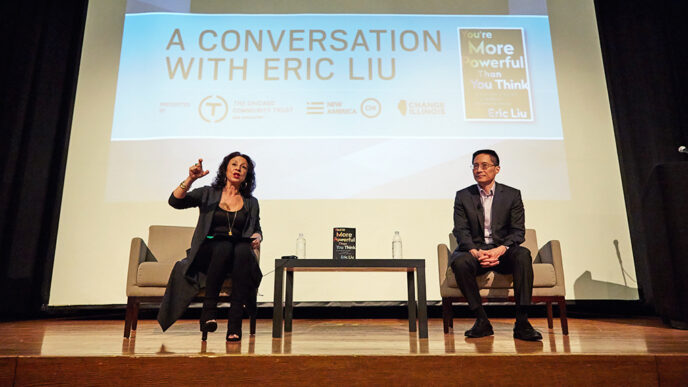 Maria Hinojosa and Eric Liu seated on stage|Maria Hinojosa and Eric Liu photographed from behind