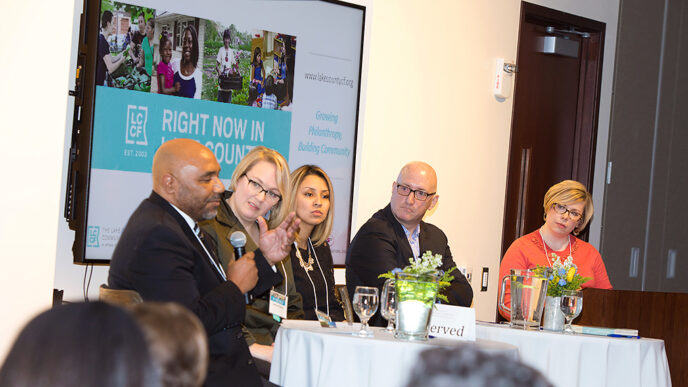 Five people seated in a row for a panel discussion