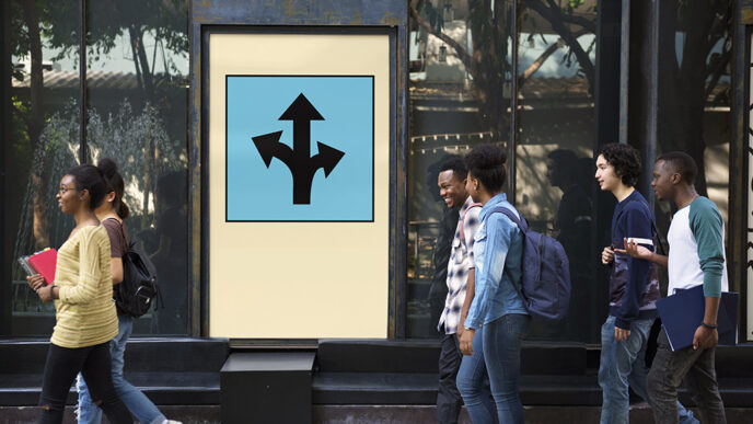 Six teenagers carrying school books walk in pairs past a large sign showing arrows in many directions