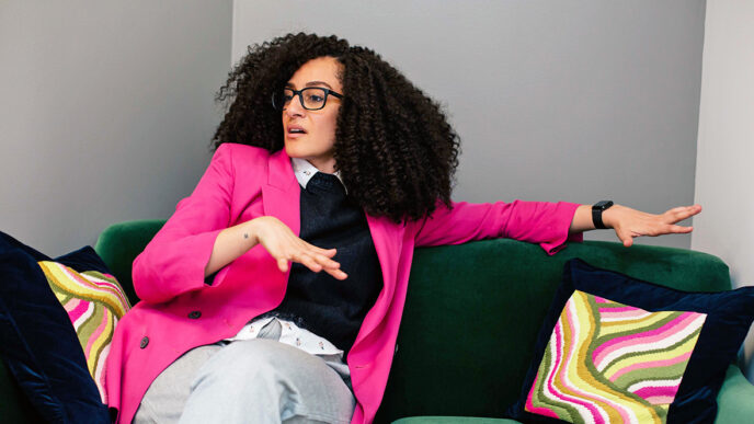 A woman wearing glasses seated on a couch