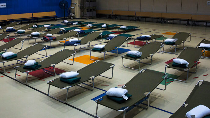 Rows of empty cots in an emergency shelter await people displaced by Hurricane Florence