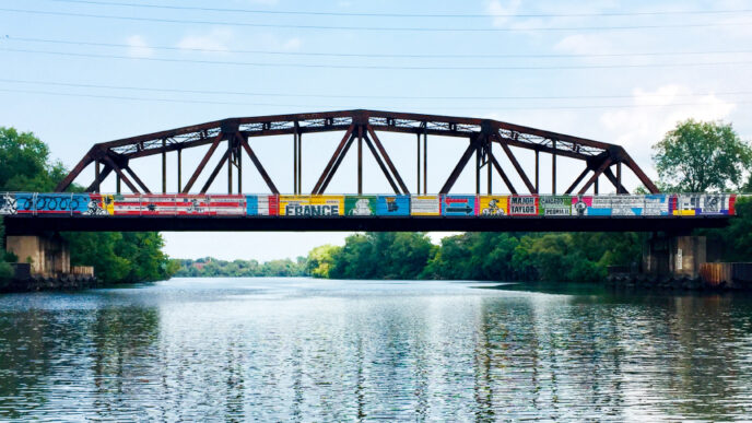 A brightly painted bridge over a river