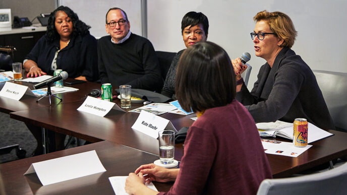 A group of panelists seated at a long conference table|A group of panelists seated at a long conference table|A group of panelists seated at a long conference table|A panelist speaks into a microphone|A group of panelists seated at a long conference table||Map of the Chicago region showing rates of food insecurity||