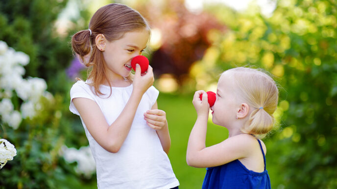 Two girls stand in a garden