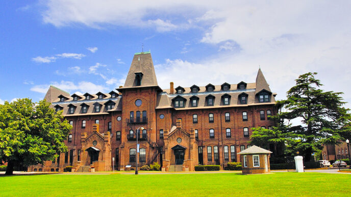 A large red brick building with a large lawn in front|Nate Sutton|Mallory Sutton